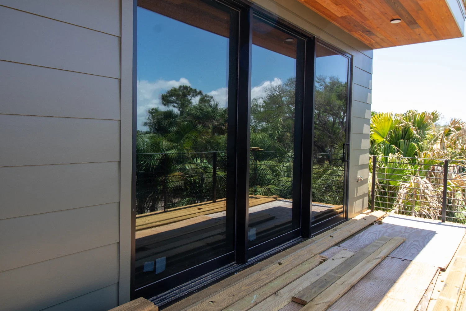 Large, expansive, and strong sliding glass door installed on a luxury home's balcony by Freedom Windows & Doors